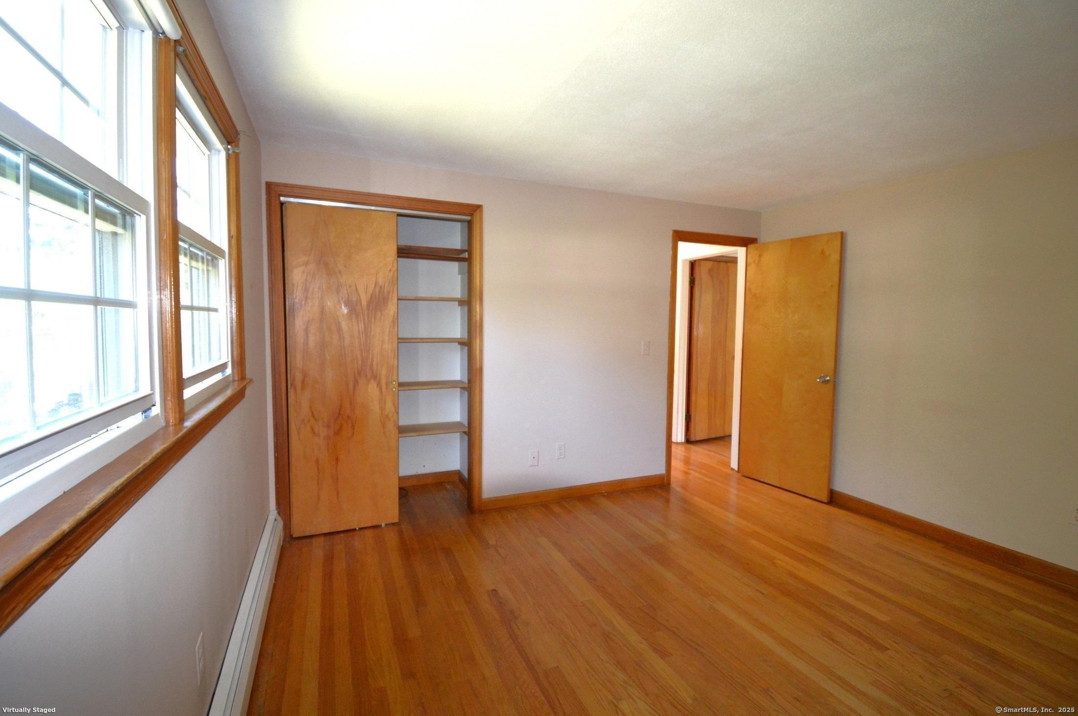 18 Overbrook Road West Hartford, CT 06107 - Photo 22 of 37 an empty room with wooden floor and windows