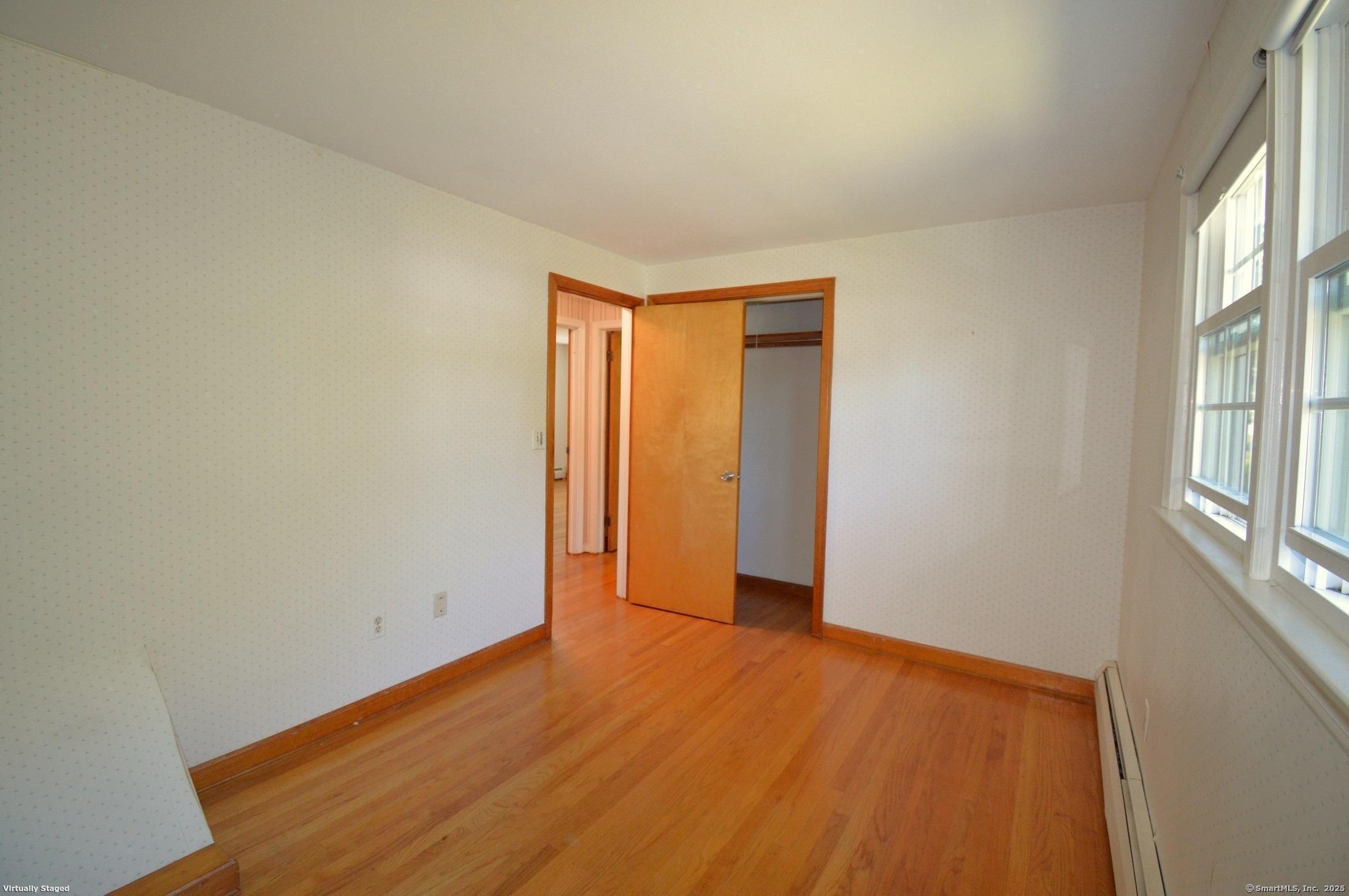 18 Overbrook Road West Hartford, CT 06107 - Photo 25 of 37 a view of an empty room with wooden floor and a window