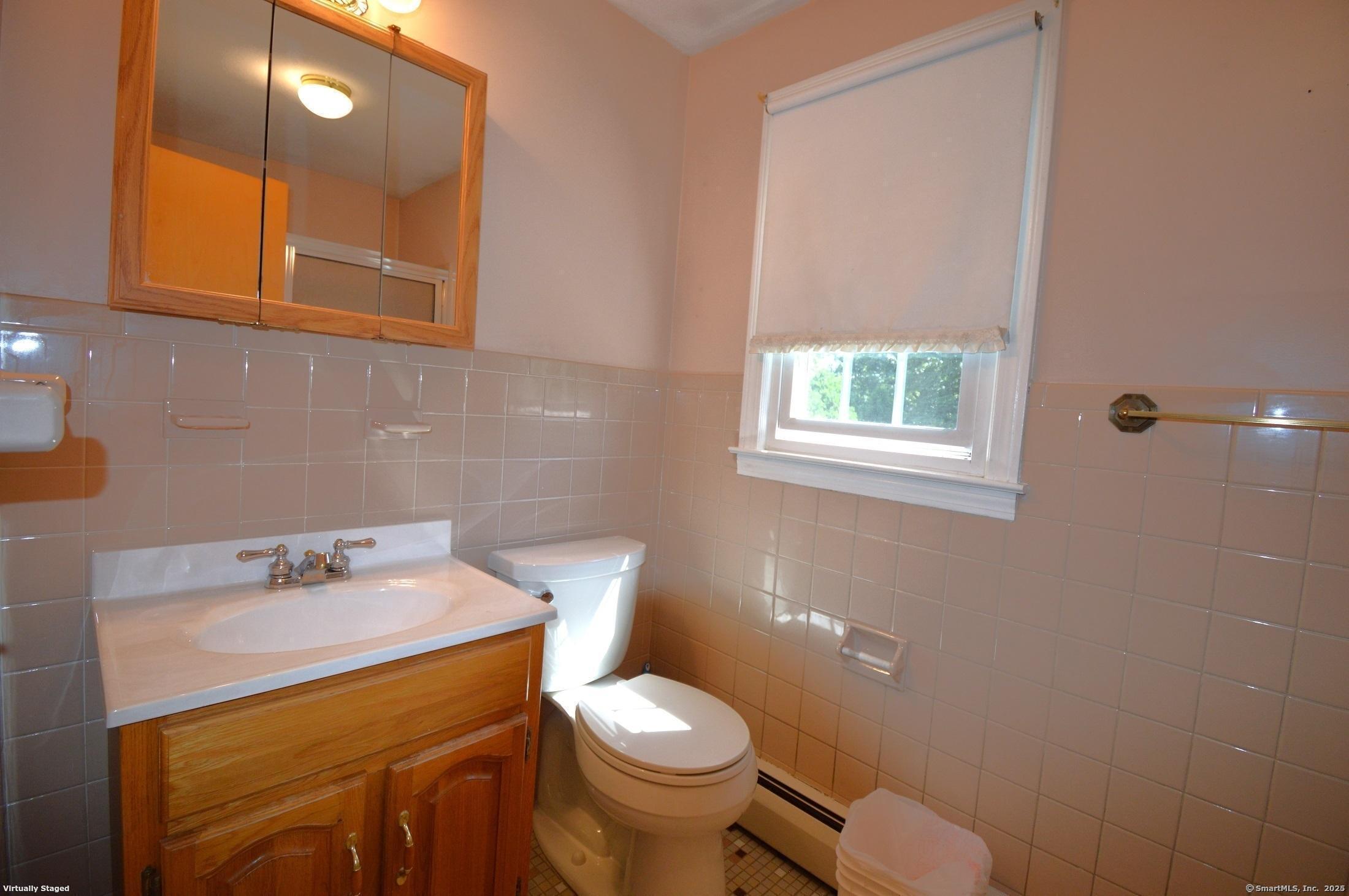 18 Overbrook Road West Hartford, CT 06107 - Photo 28 of 37 a bathroom with a sink a toilet and mirror