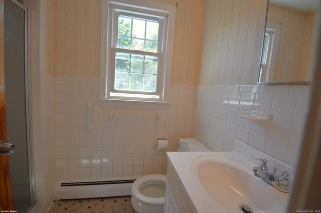 a white toilet sitting next to a bathroom sink