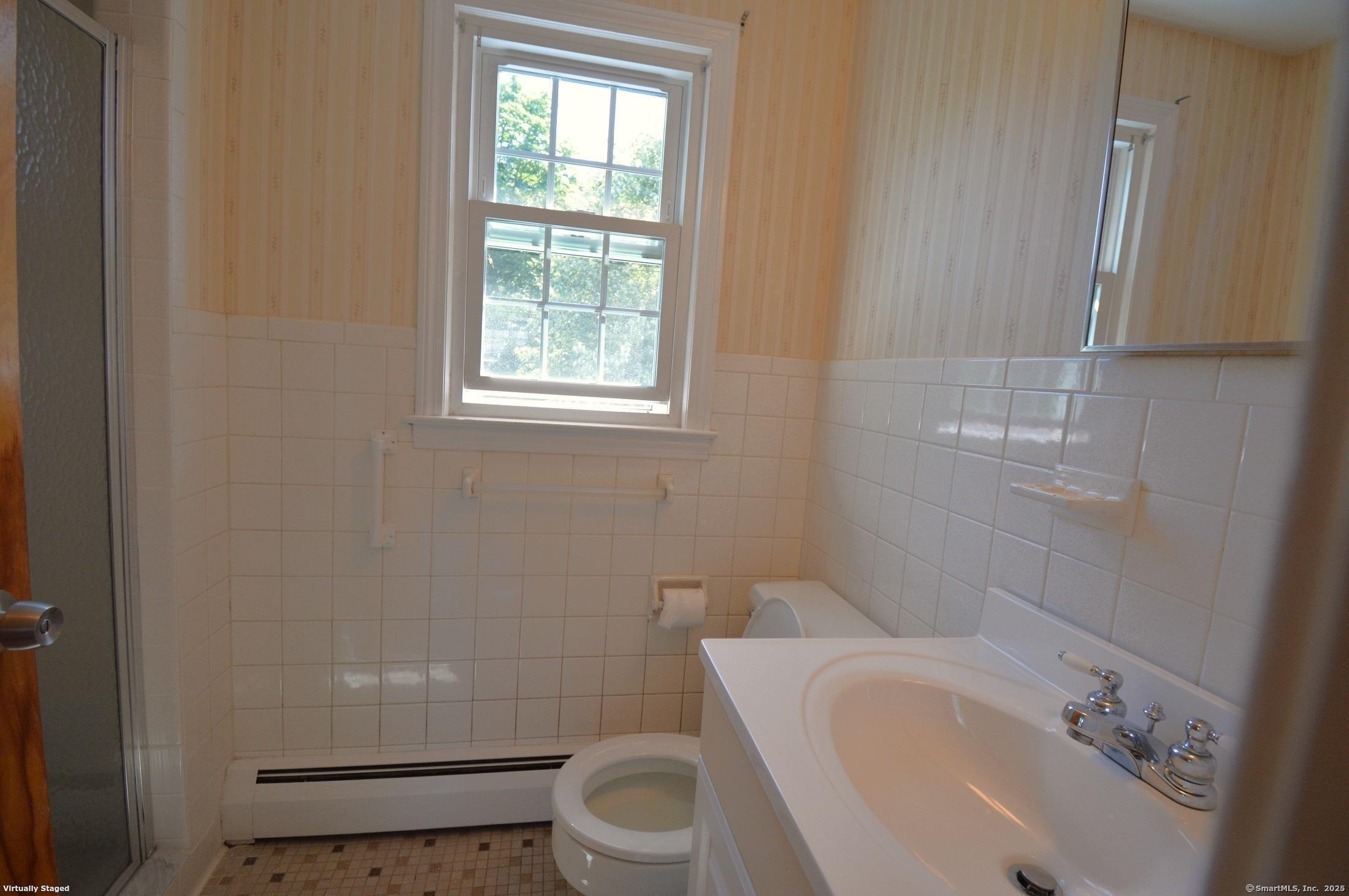 18 Overbrook Road West Hartford, CT 06107 - Photo 29 of 37 a white toilet sitting next to a bathroom sink