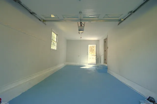 an empty room with windows and entrance