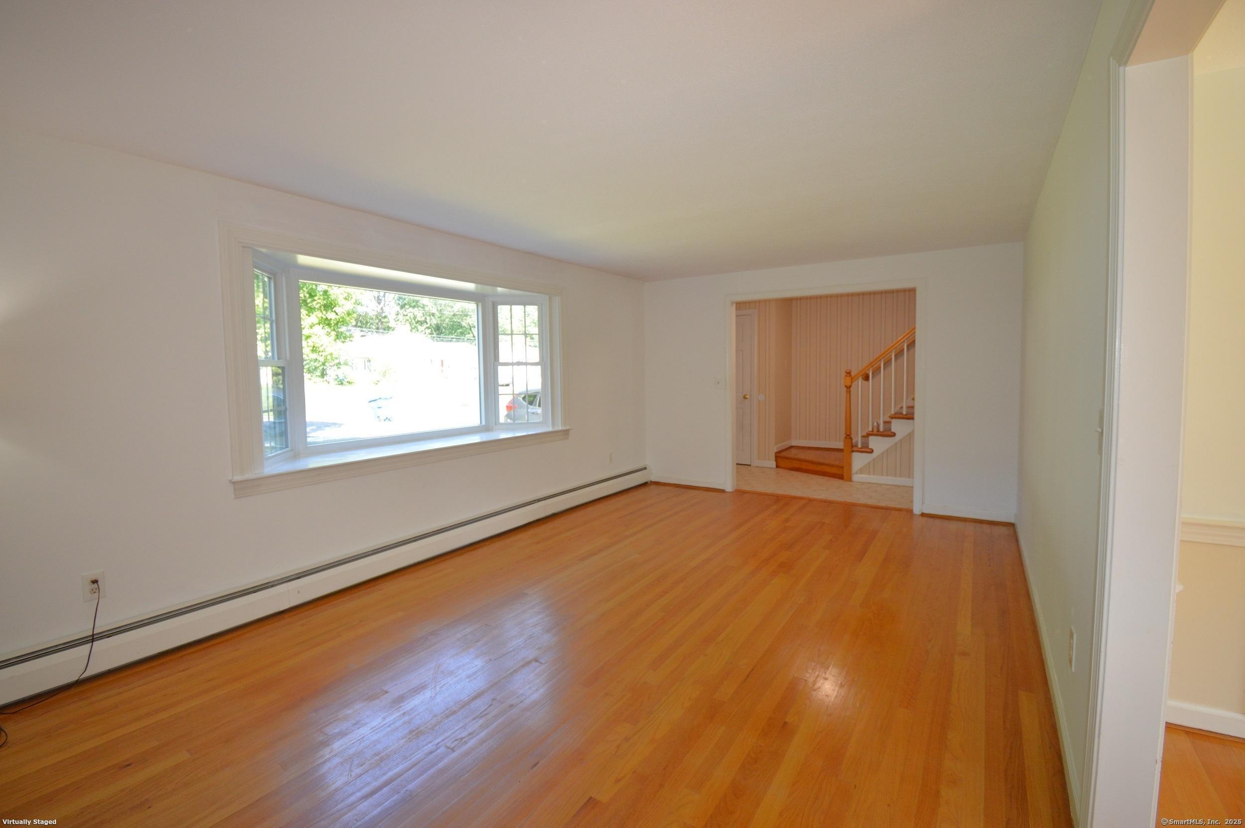 18 Overbrook Road West Hartford, CT 06107 - Photo 4 of 37 an empty room with wooden floor and windows