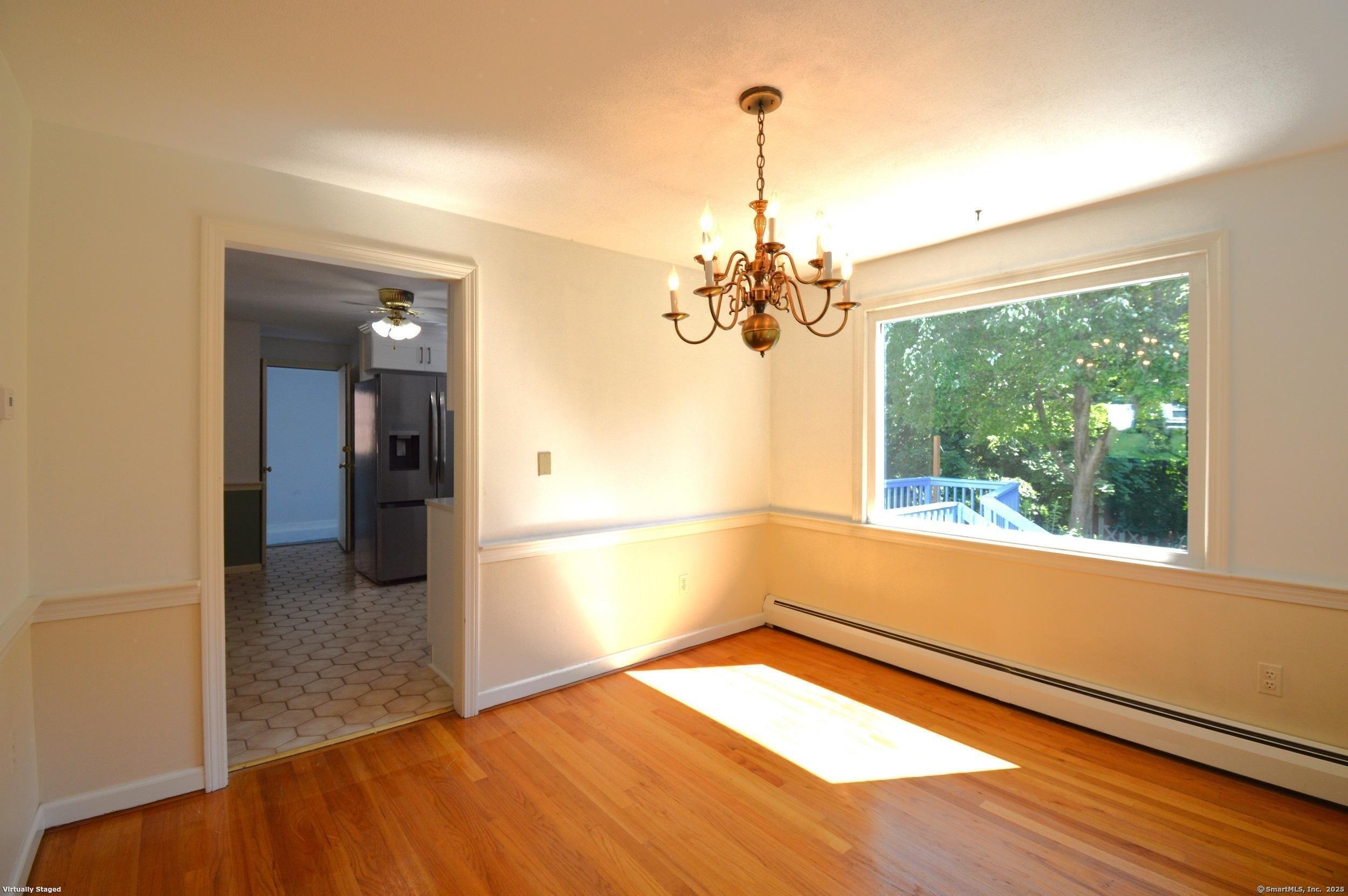 18 Overbrook Road West Hartford, CT 06107 - Photo 6 of 37 a view of empty room with wooden floor and fan