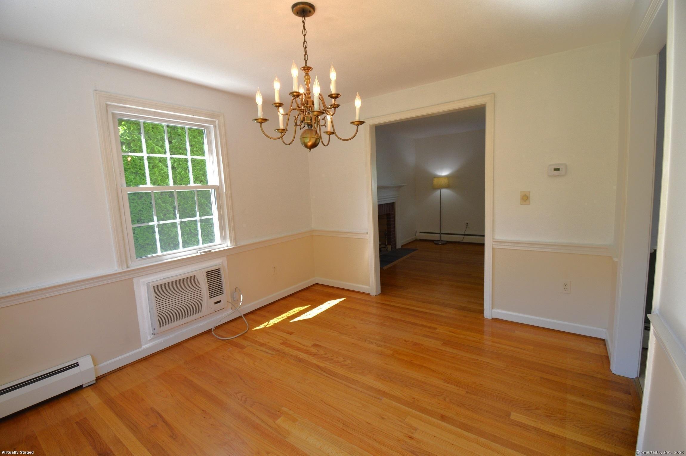 18 Overbrook Road West Hartford, CT 06107 - Photo 7 of 37 a view of an empty room with a window and wooden floor