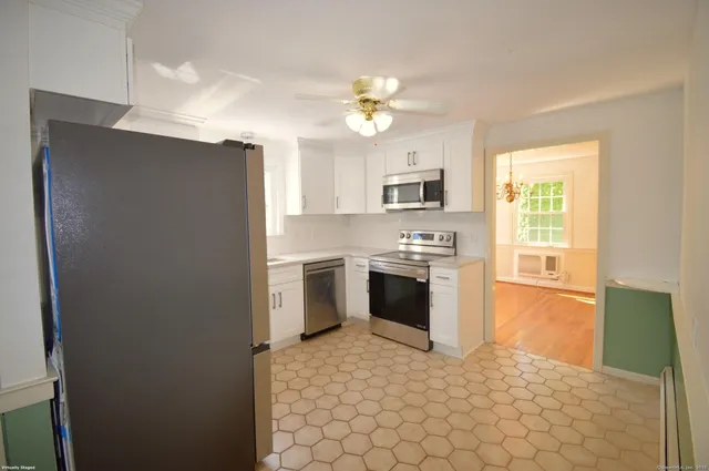 a kitchen with a stove a sink and a refrigerator