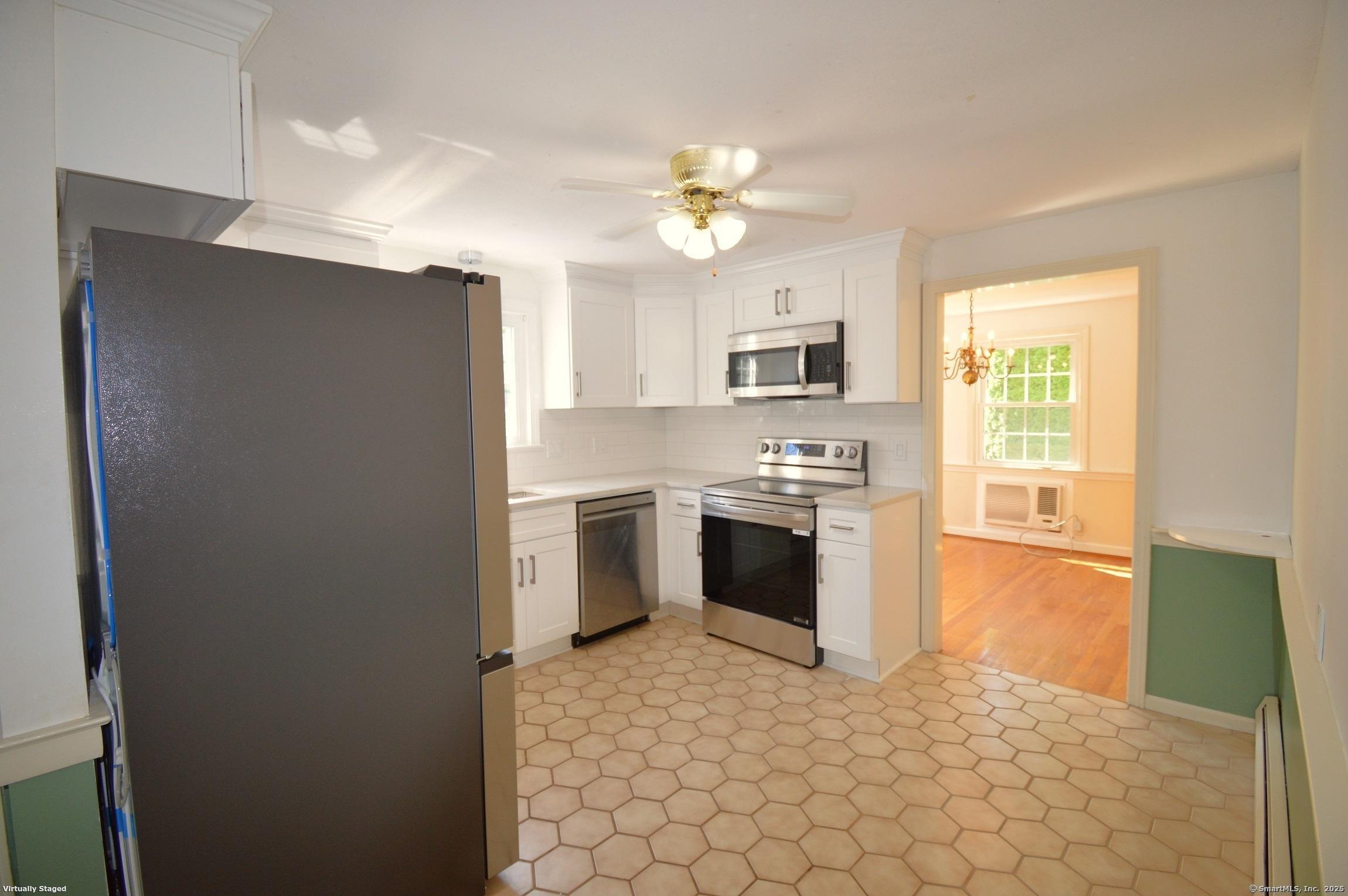 18 Overbrook Road West Hartford, CT 06107 - Photo 10 of 37 a kitchen with a stove a sink and a refrigerator