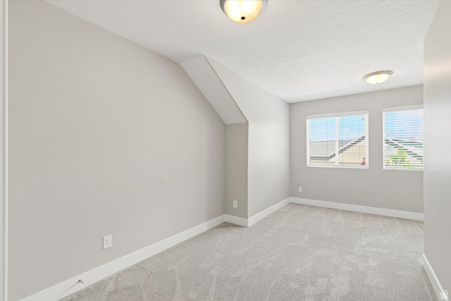 847 225 South Springville, UT 84663 - Photo 15 of 23 Carpeted interior room with white baseboards, two windows, and two flush-mount ceiling lights