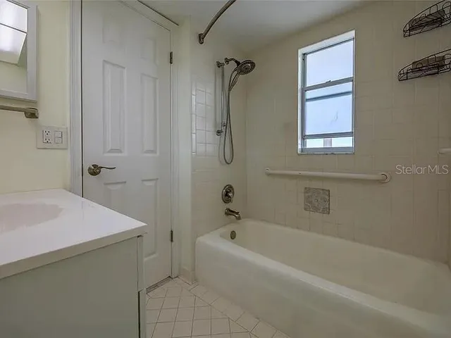 a bathroom with a glass door shower and a sink