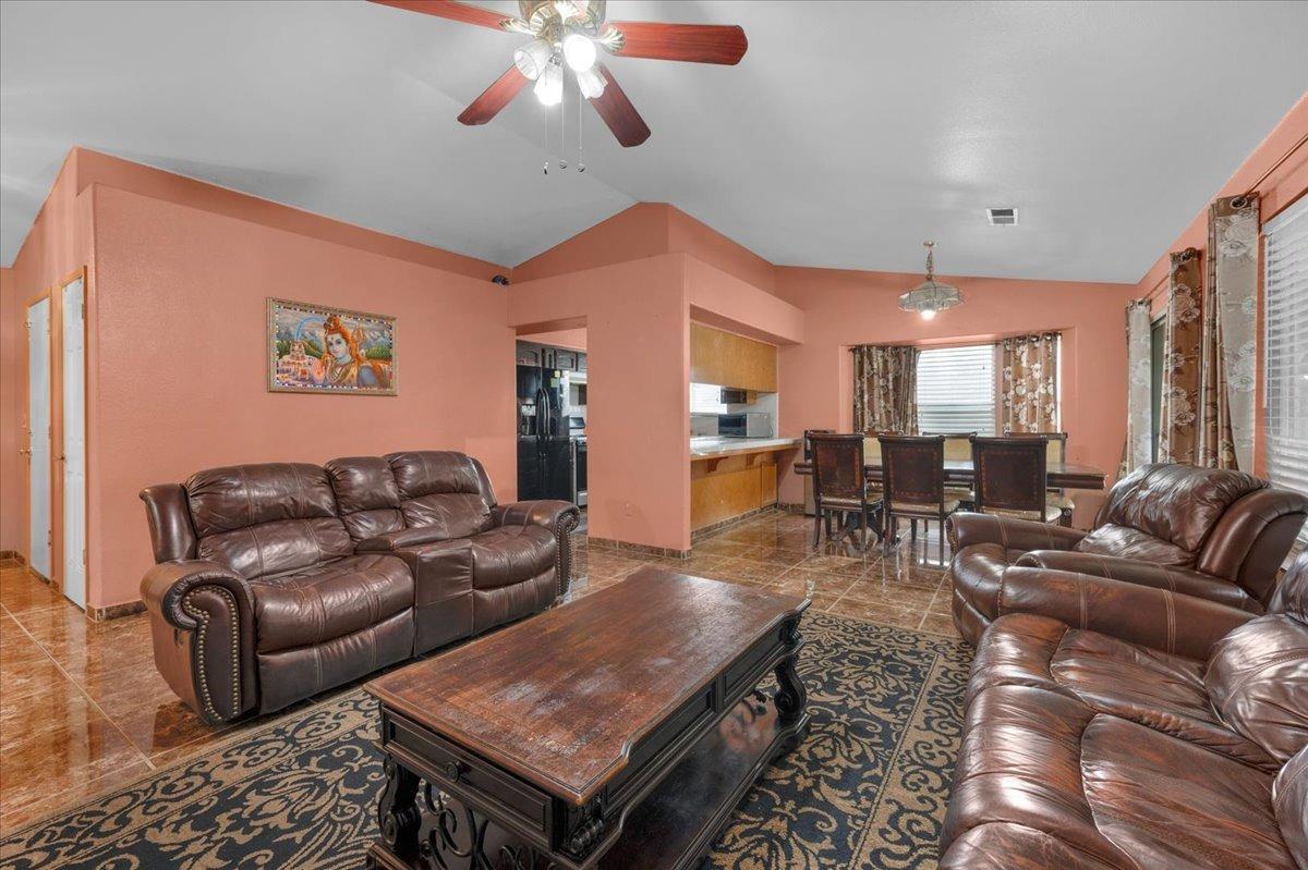 14440 West E Street Kerman, CA 93630 - Photo 3 of 13 a living room with furniture and a large window