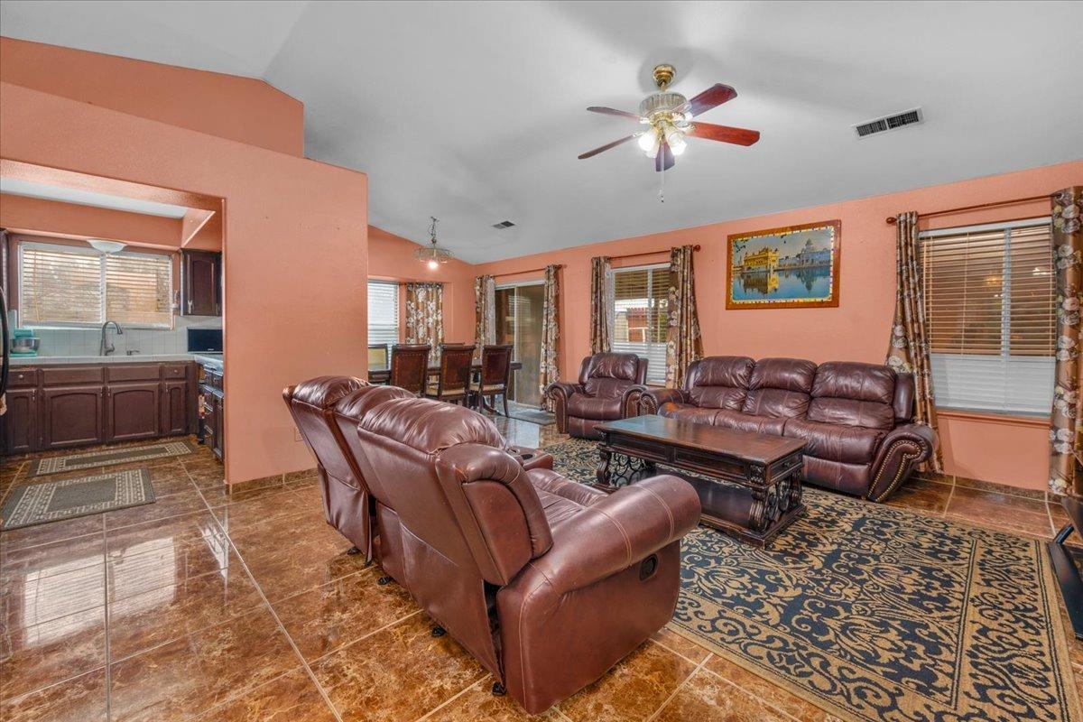 14440 West E Street Kerman, CA 93630 - Photo 4 of 13 a living room with furniture ceiling fan and a rug