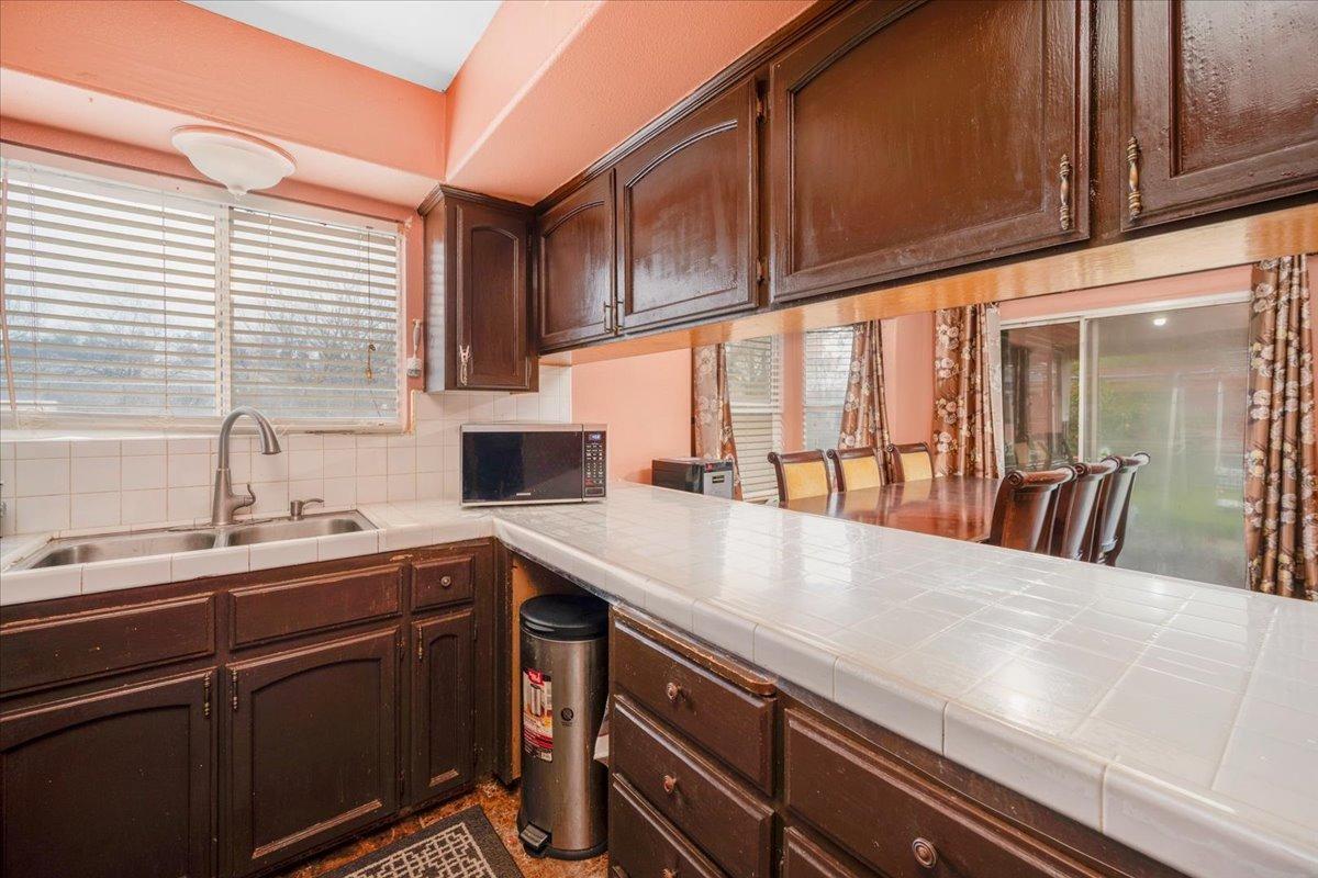 14440 West E Street Kerman, CA 93630 - Photo 5 of 13 a kitchen with a sink and cabinets