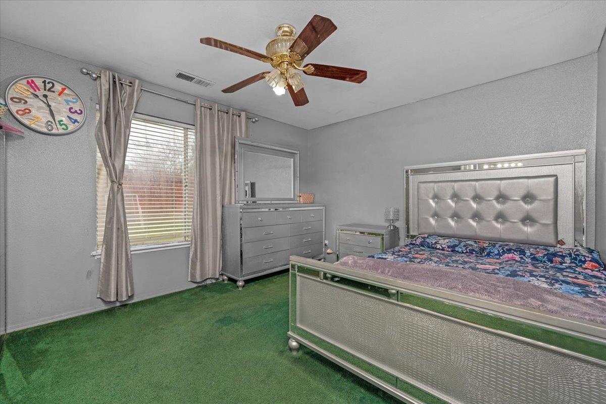 14440 West E Street Kerman, CA 93630 - Photo 6 of 13 a room with furniture and a window