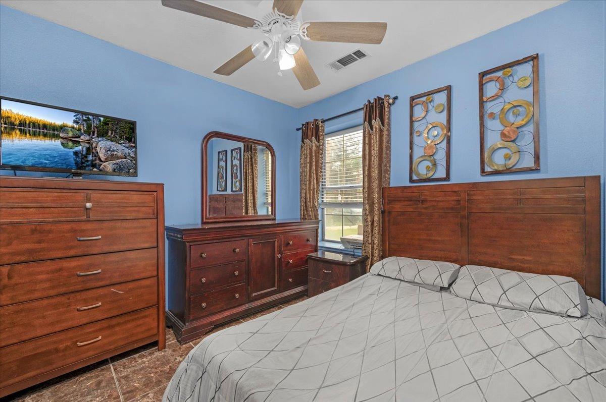 14440 West E Street Kerman, CA 93630 - Photo 7 of 13 a bedroom with a bed and a dresser