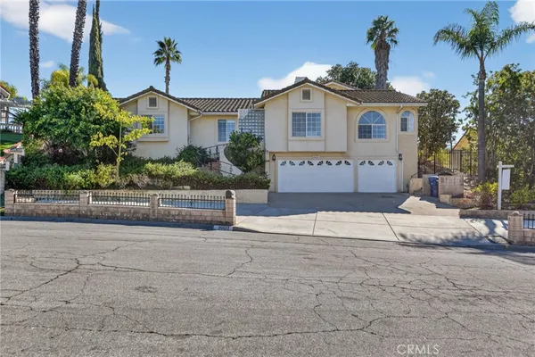 a front view of a house with a yard and a garage