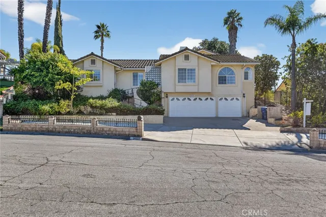 a front view of a house with a yard and a garage