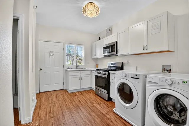 a view of a hallway with wooden floor and closet