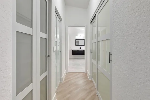 a large white kitchen with a sink a stove and a microwave