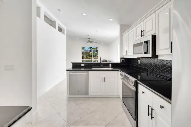 a kitchen with cabinets and appliances
