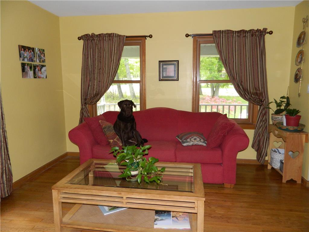 328 Pin Oak Road Stroudsburg, PA 18360 - Photo 10 of 37 Hardwood floors complement this inviting living space with views of lush greenery.