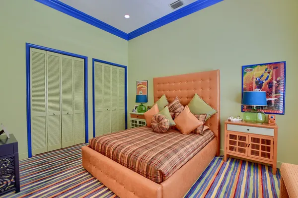 a spacious bedroom with two beds and a chandelier