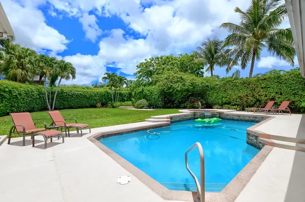 a view of swimming pool with chairs