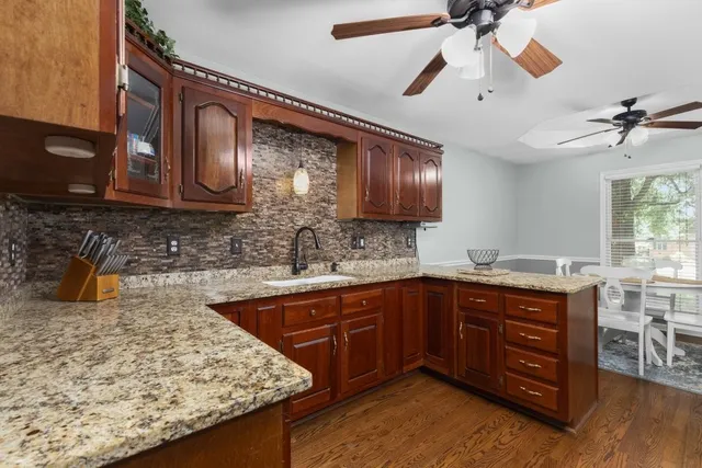 a kitchen with a sink appliances and cabinets