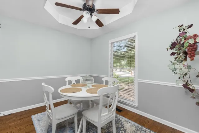 a view of a dining room with furniture window and wooden floor