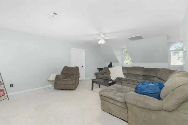 a living room with furniture and a lamp