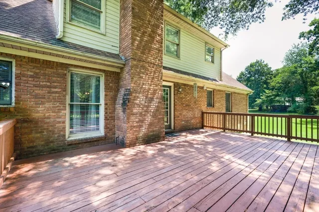 a view of backyard with a deck