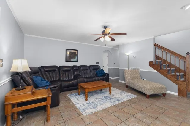 a living room with furniture and stairs