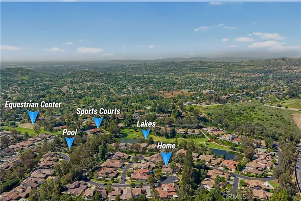 a view of a dining room with furniture a livingroom and chandelier