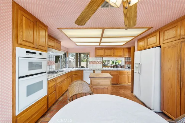 a view of a hallway with wooden floor and windows