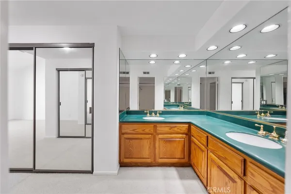 a view of a lush green field with mountains in the background