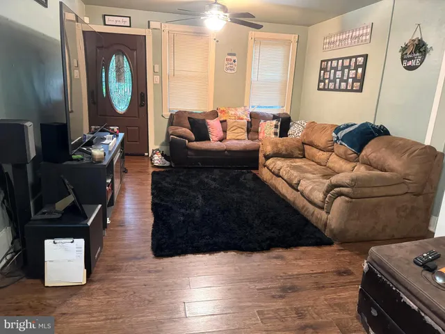 a living room with furniture and a mirror