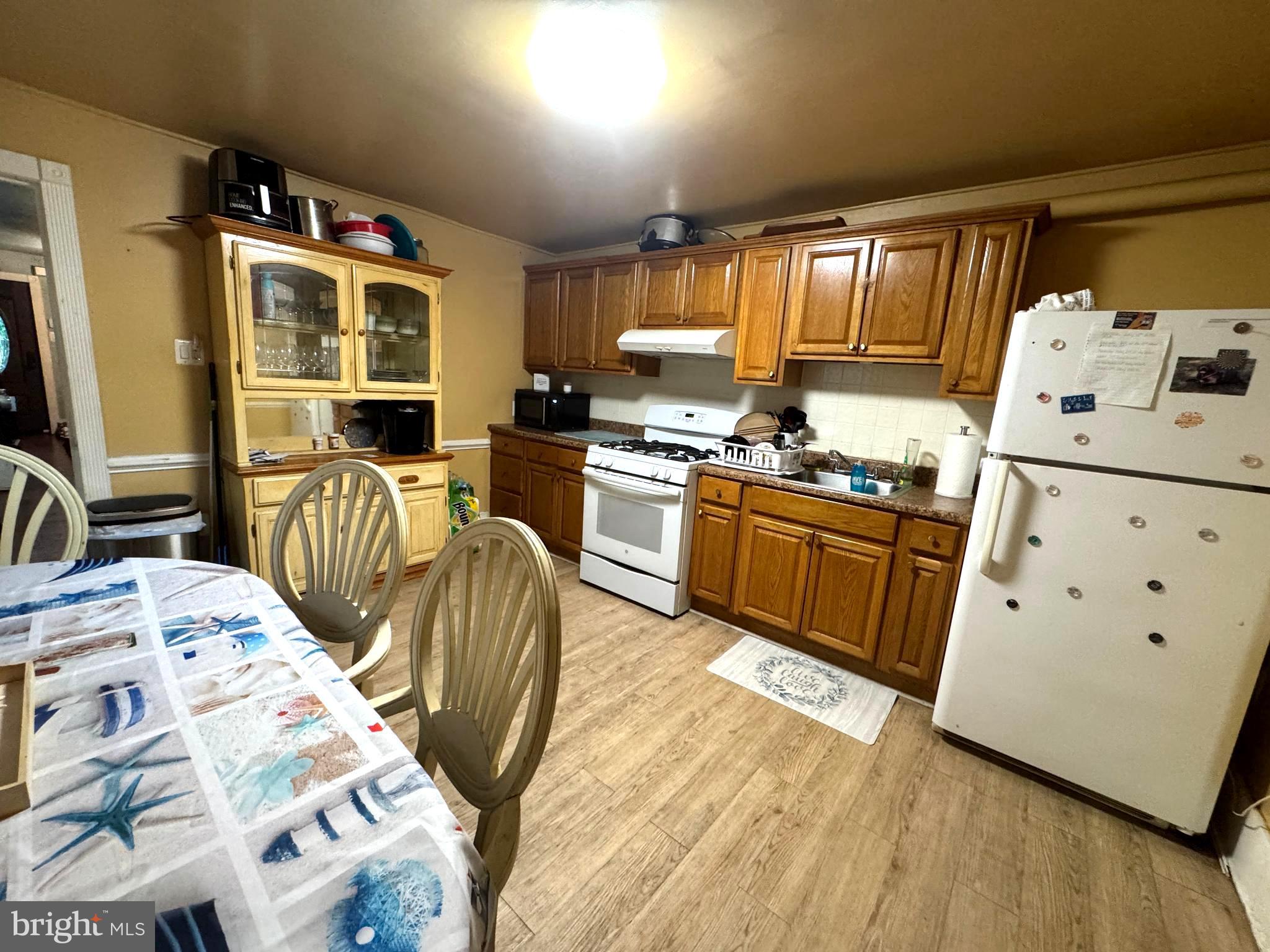279-281 Arch Street Palmyra, NJ 08065 - Photo 23 of 29 a kitchen with stainless steel appliances granite countertop a sink dishwasher stove and refrigerator with wooden floor