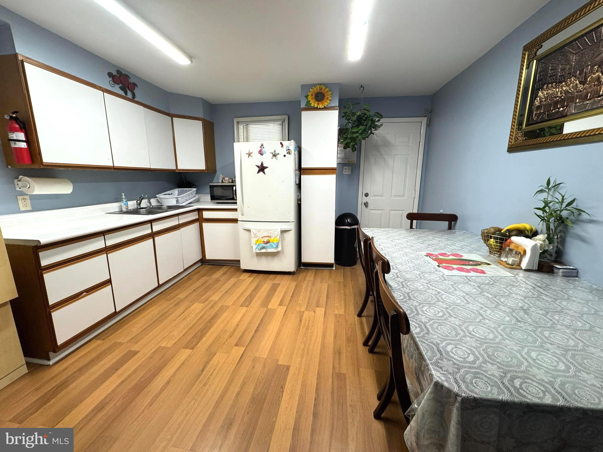 279-281 Arch Street Palmyra, NJ 08065 - Photo 7 of 29 a kitchen with a sink and wooden floor