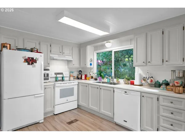 a kitchen with a window sink and cabinets