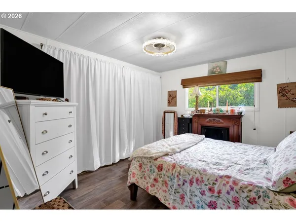 a bedroom with a bed and flat screen tv