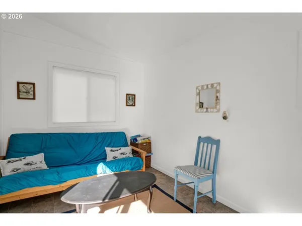 a living room with furniture a flat screen tv and a window