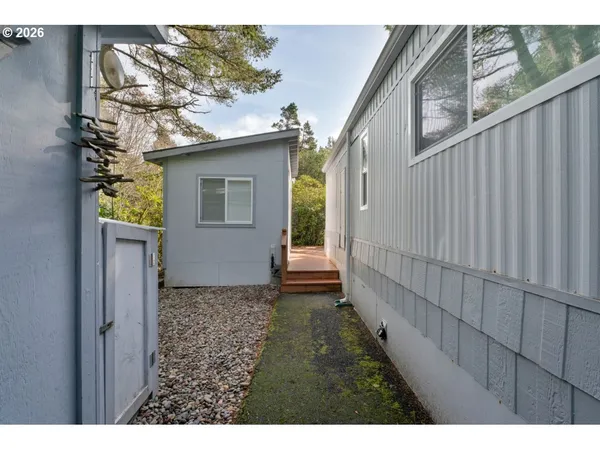 a view of house with outdoor space and trees