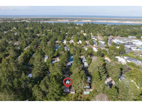 a view of a swimming pool with lawn chairs under an umbrella