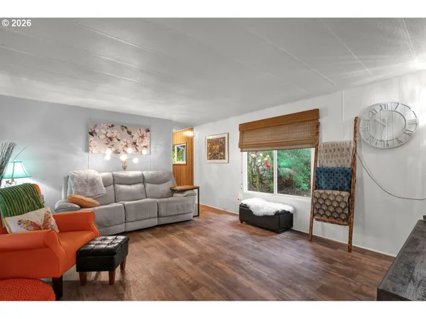a living room with furniture a rug and a large window