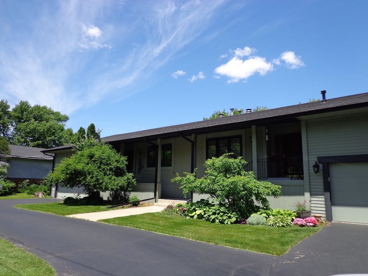 5724 Spring Brook Road Rockford, IL 61114 - Photo 1 of 37 a view of a house with a yard and plants