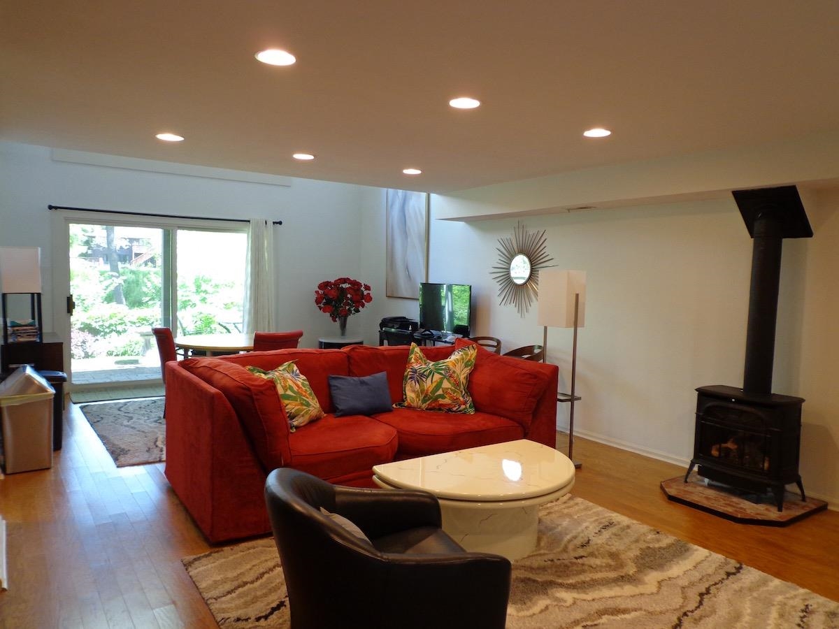 5724 Spring Brook Road Rockford, IL 61114 - Photo 20 of 37 a living room with furniture a wooden floor and a large window
