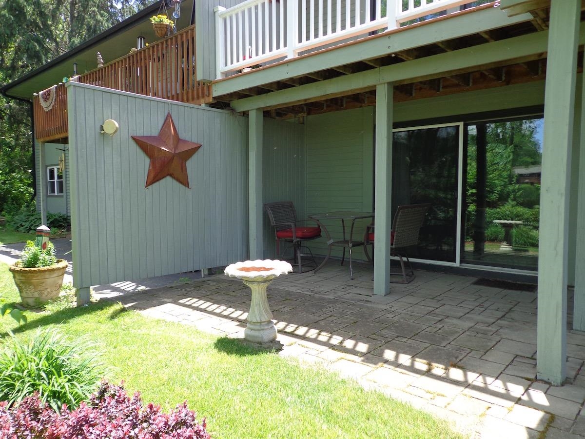 5724 Spring Brook Road Rockford, IL 61114 - Photo 36 of 37 a backyard of a house with table and chairs