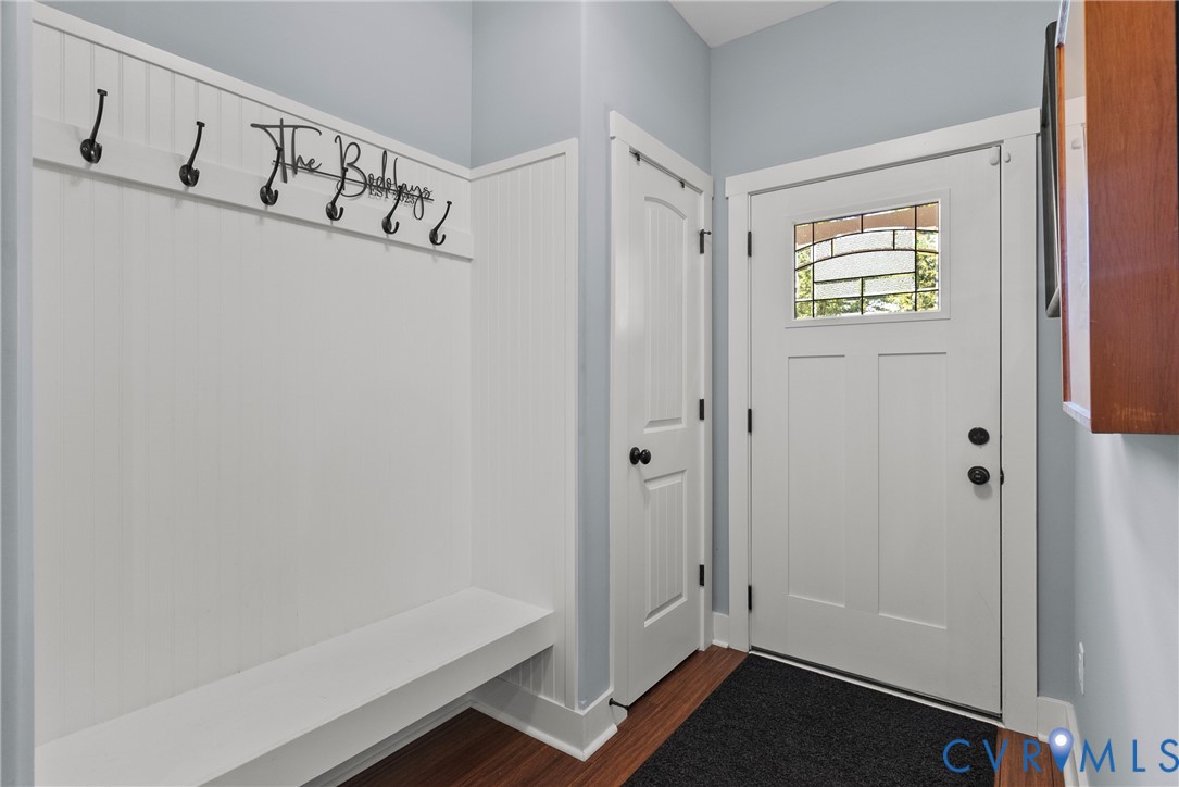 Mudroom featuring dark wood-style flooring