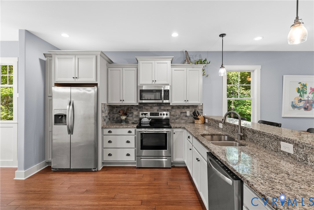 Kitchen featuring stainless steel appliances, dark
