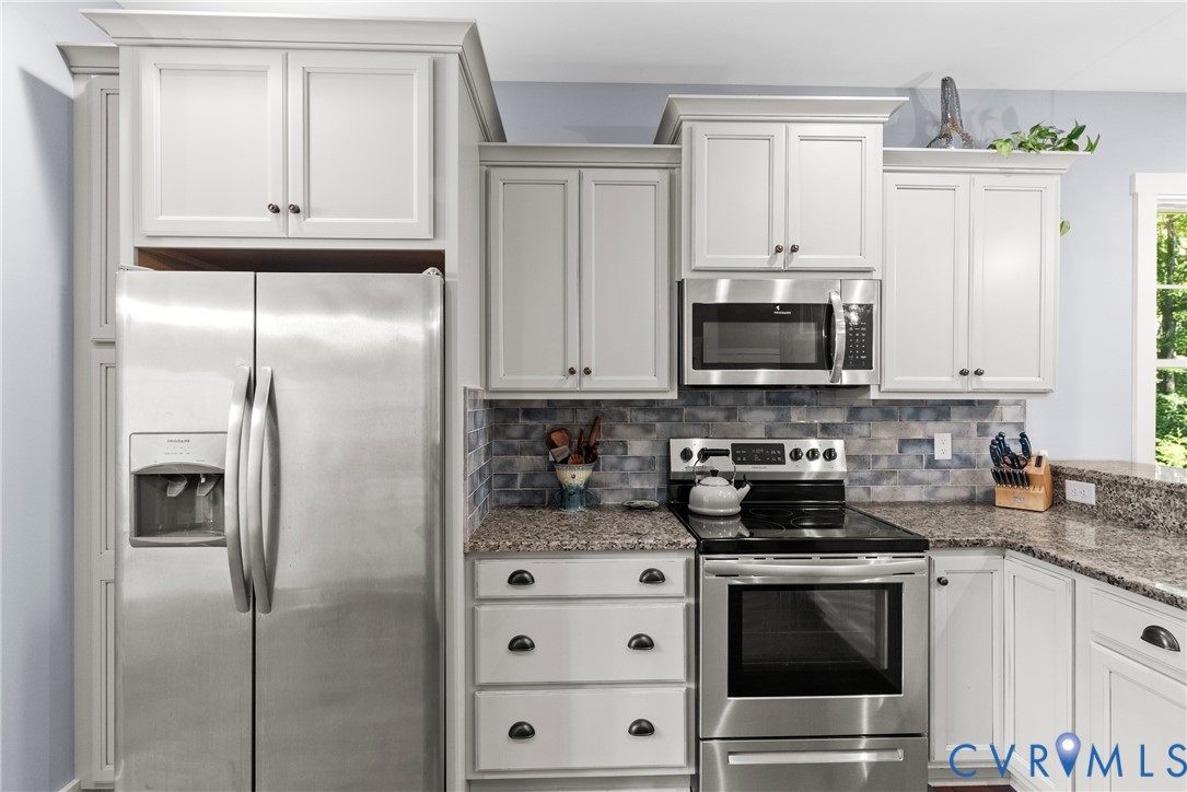 Kitchen with appliances with stainless steel finis