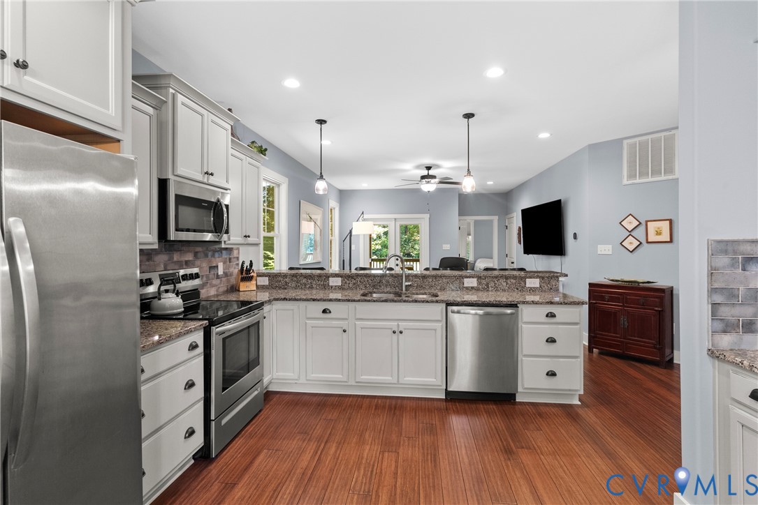 Kitchen featuring backsplash, appliances with stai